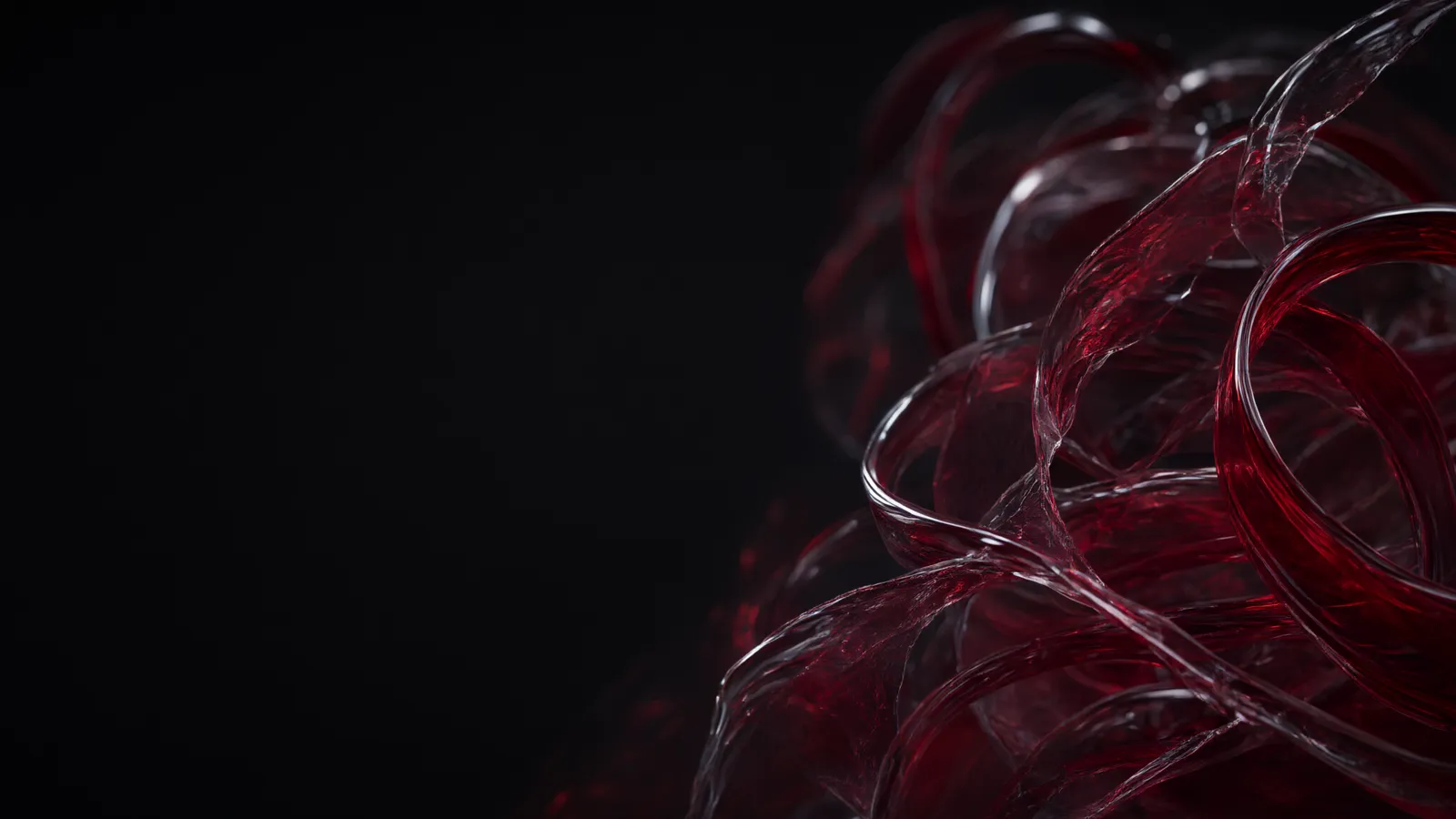 Coiled crimson glass forms on a dark background.